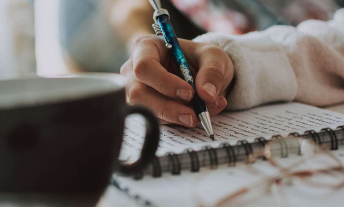close-up-of-woman-journaling