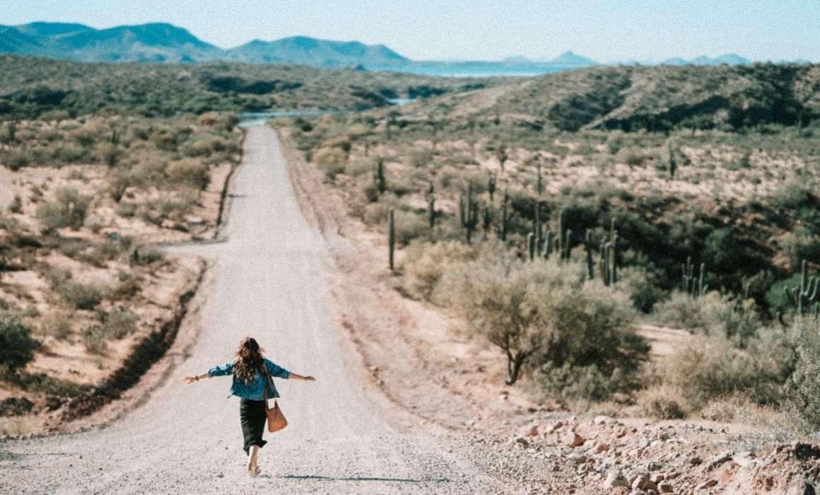 woman-walking-on-dirt-road