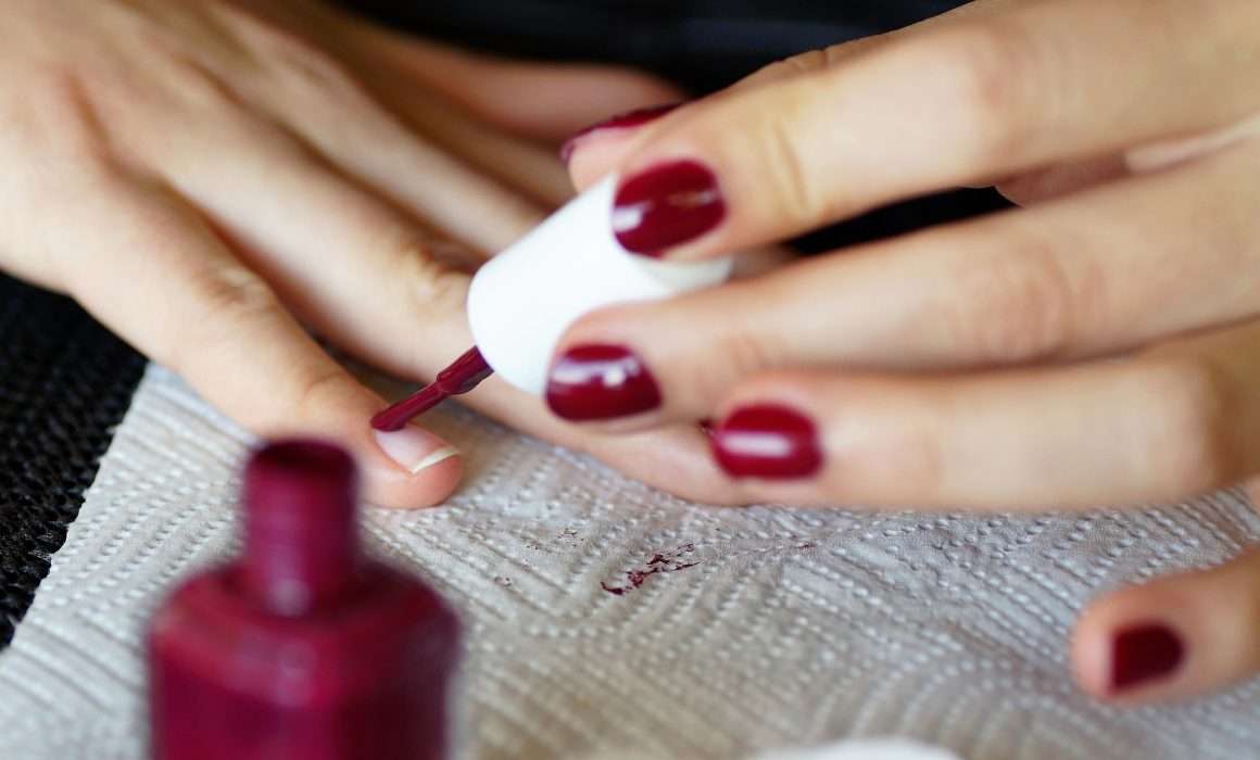 close-up-painting-nails-burgundy-self-care