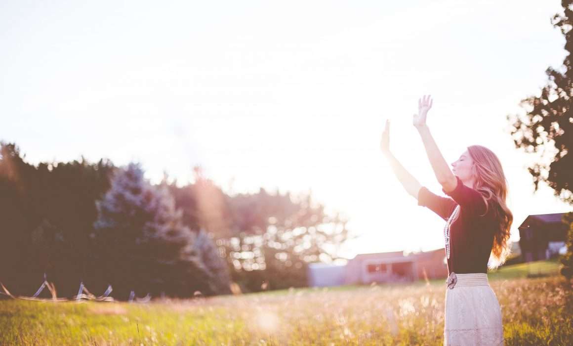 woman-lifting-arms-to-the-sky-in-gratitude