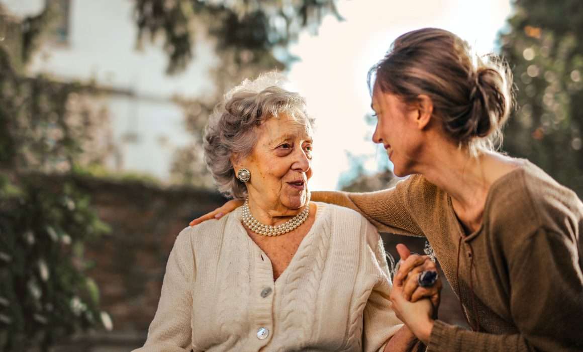 two-women-one-old-one-young-holding-hands