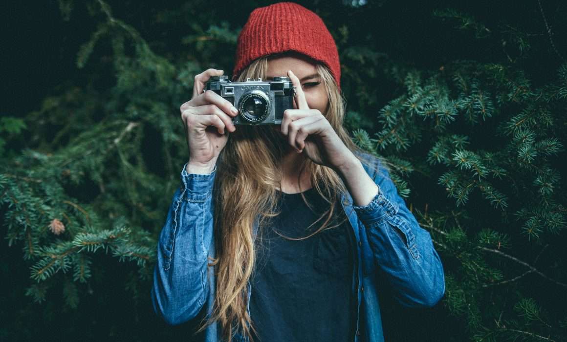 woman-holding-camera-up-to-eye