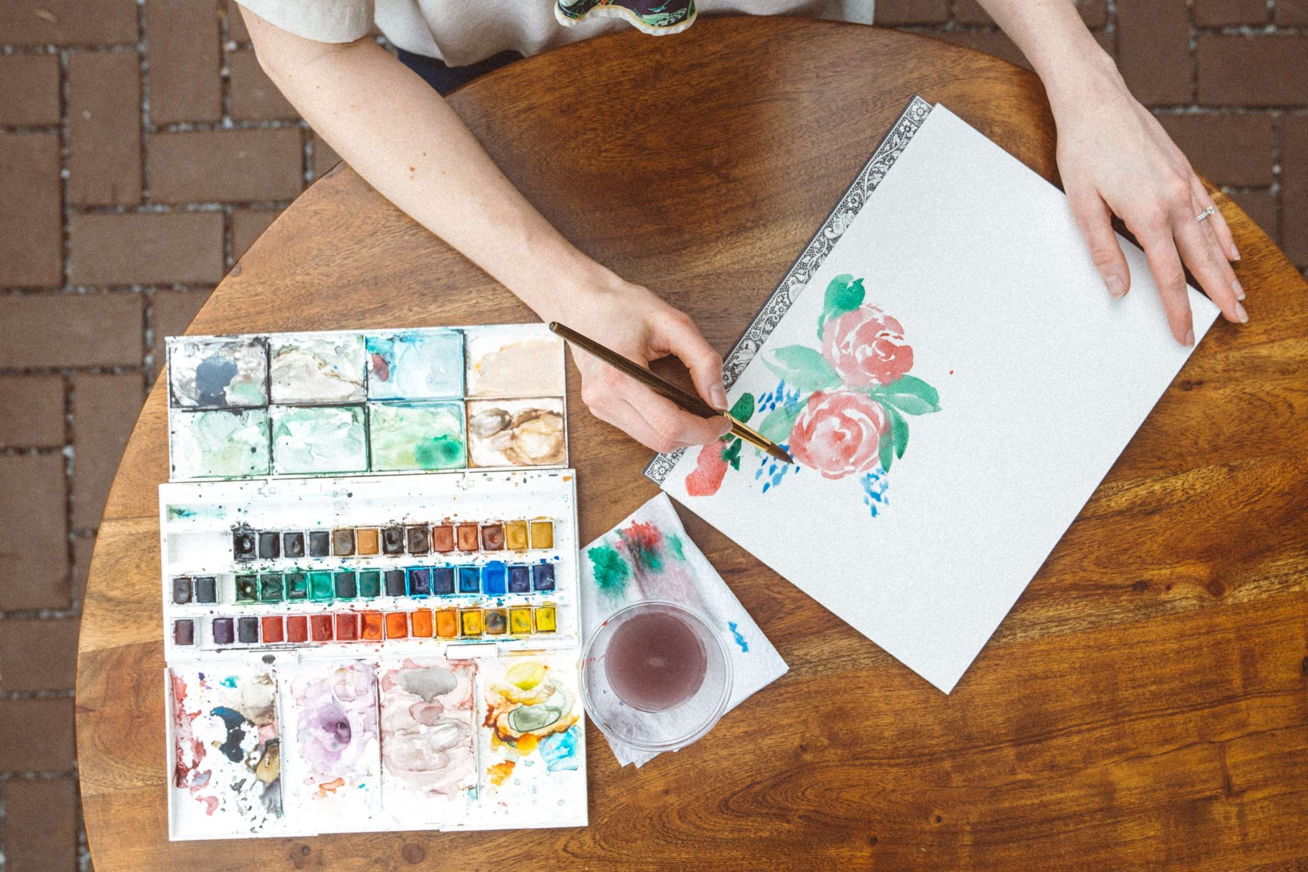 overhead-view-person-painting-flowers