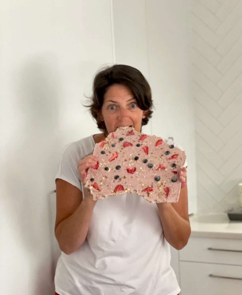 healthy-snack-yogurt-bark-woman-taking-bite