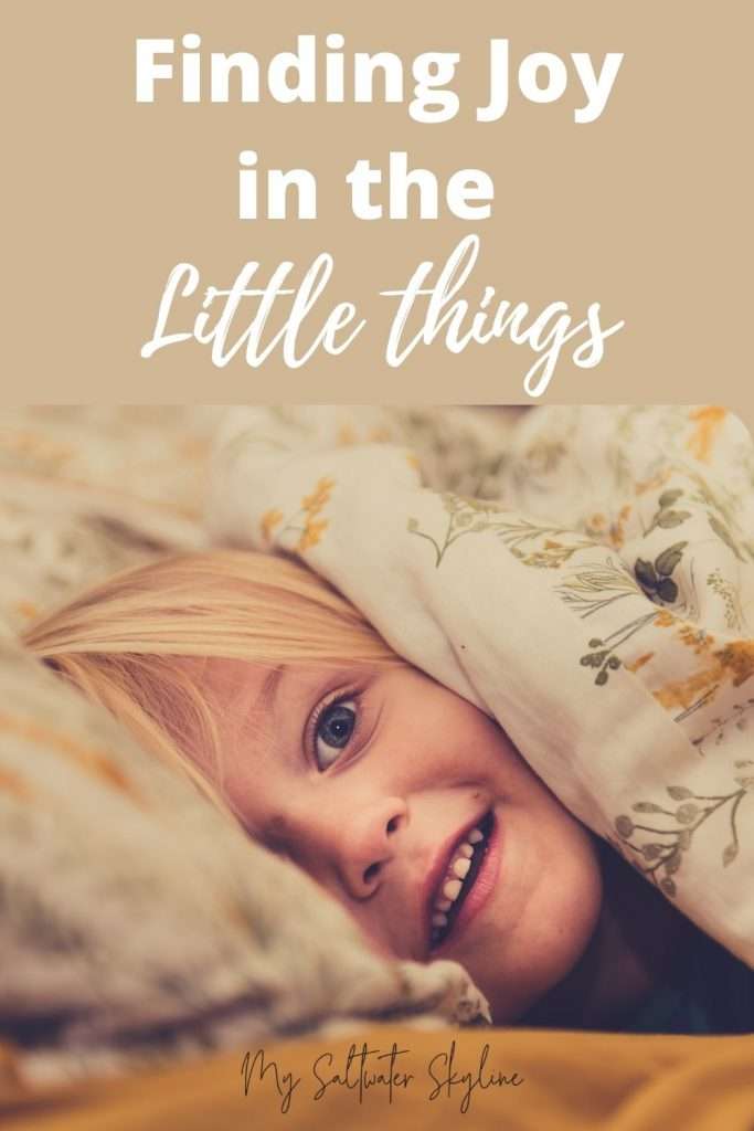 finding-joy-in-the-little-things-girl-peeping-out-from-under-duvet-pin