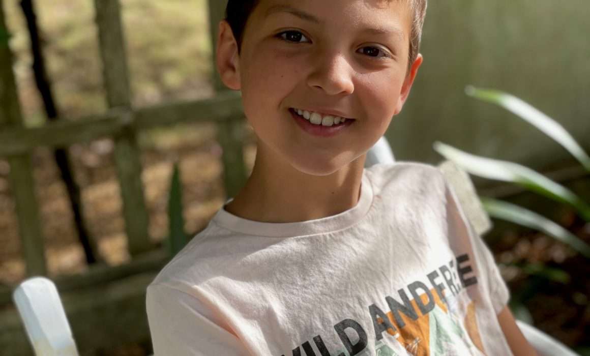young-boy-happy-smile-healthy-after-illness-strength-through-pain-blog-post