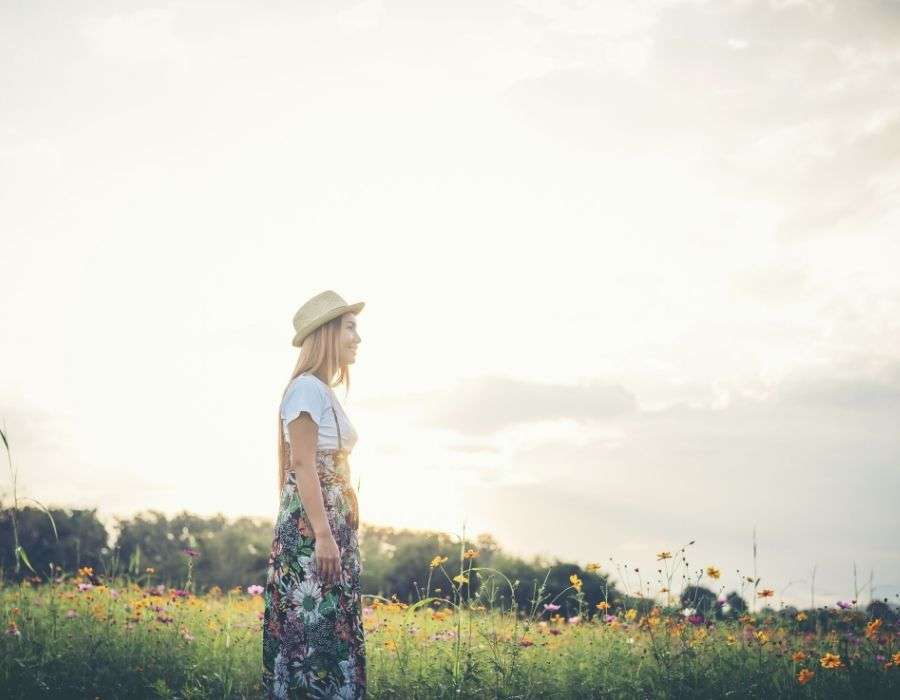 woman-long-blonde-hair-straw-hat-standing-in-field-of-flowers-good-day-blog-post