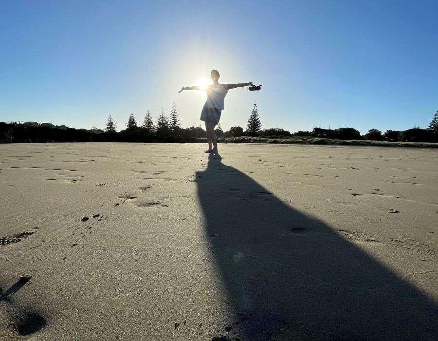 woman-on-beach-silhouette-arms-out-to-sides-self-worth