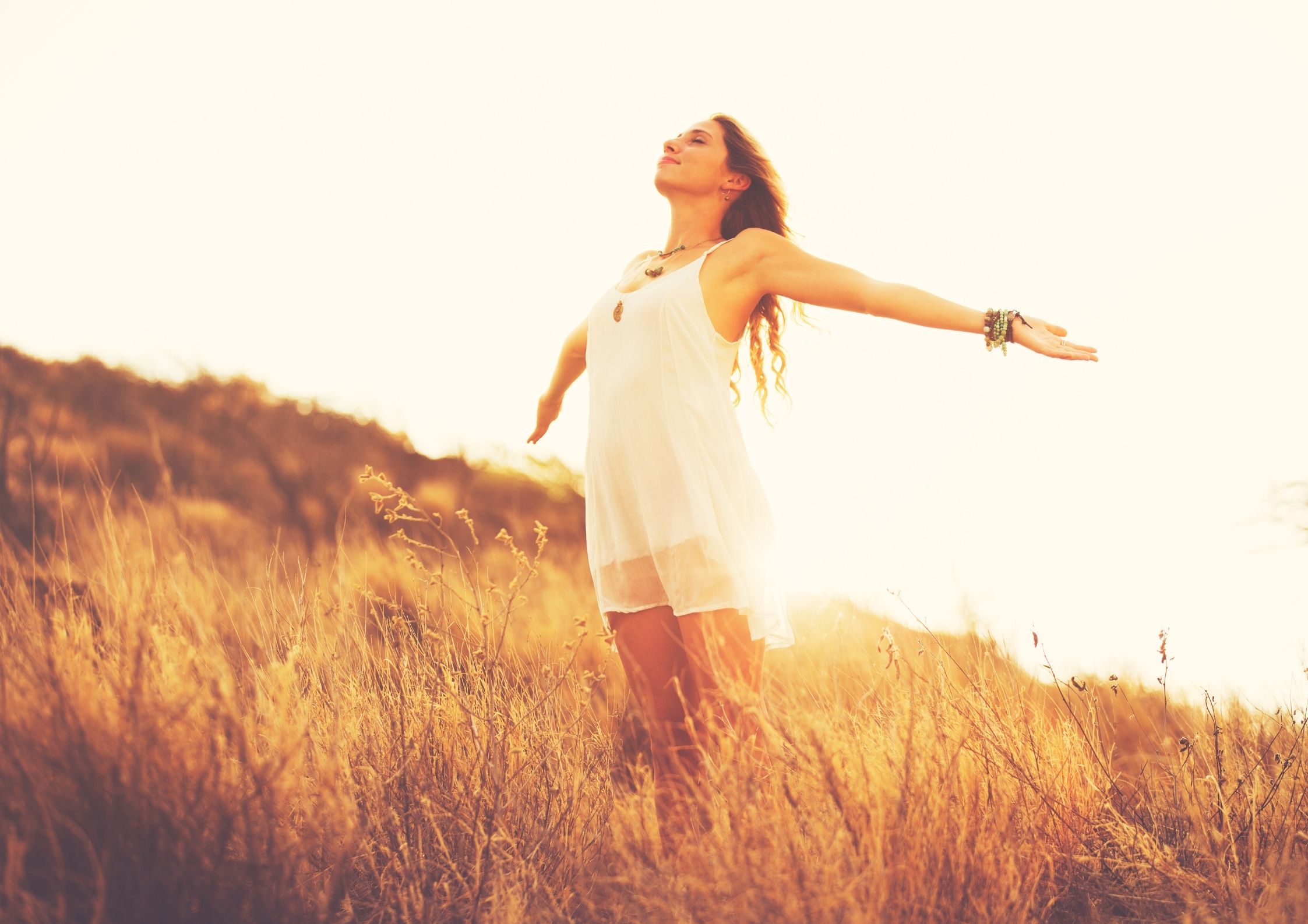 woman-arms-outstretched-sun-behind-her-face-to-sky-feeling-of-self-worth-know-your-story-blog