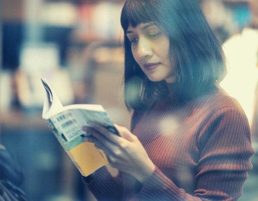 woman-dark-bob-reading-book-in-bookstore