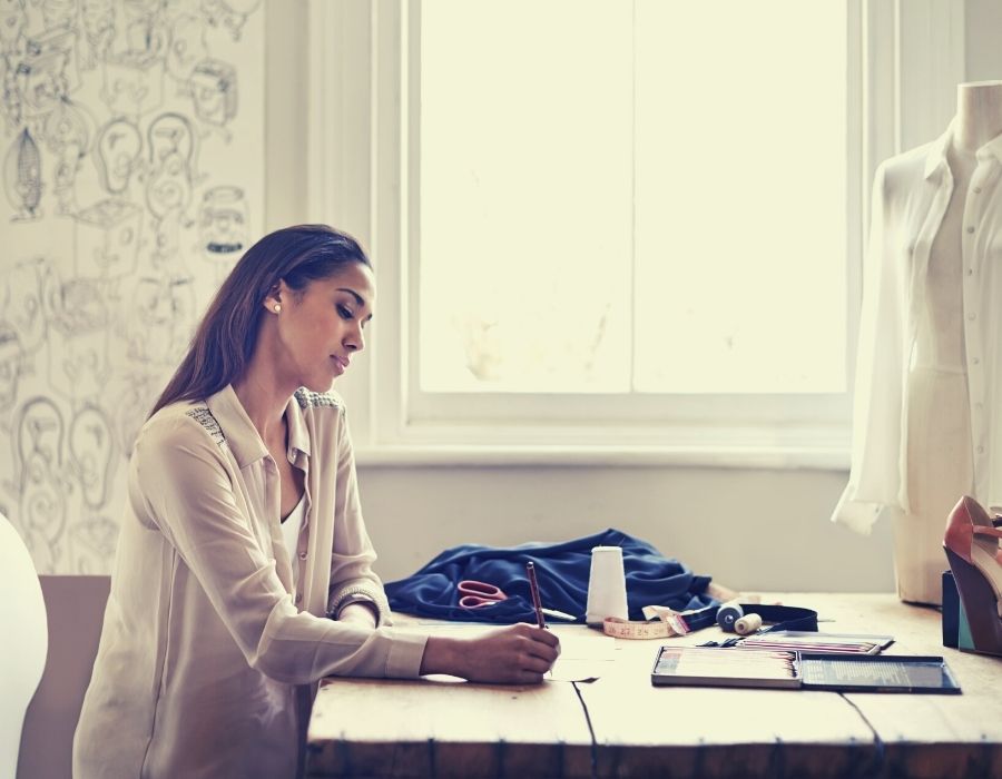 woman-at-desk-writing-focused-and-in-flow