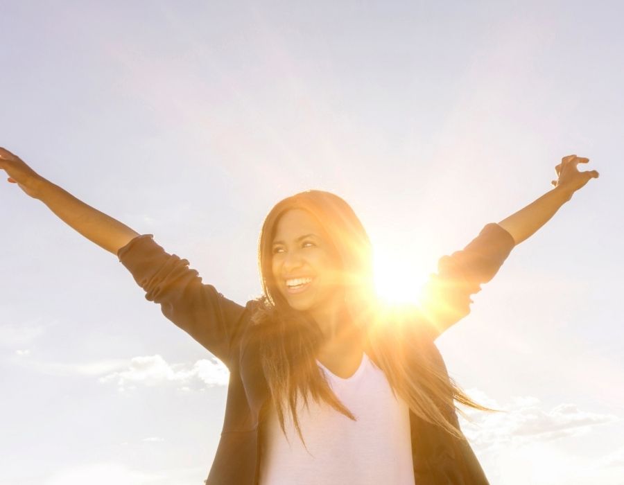 love-yourself-woman-arms-outstretched-smiling-happy-in-herself