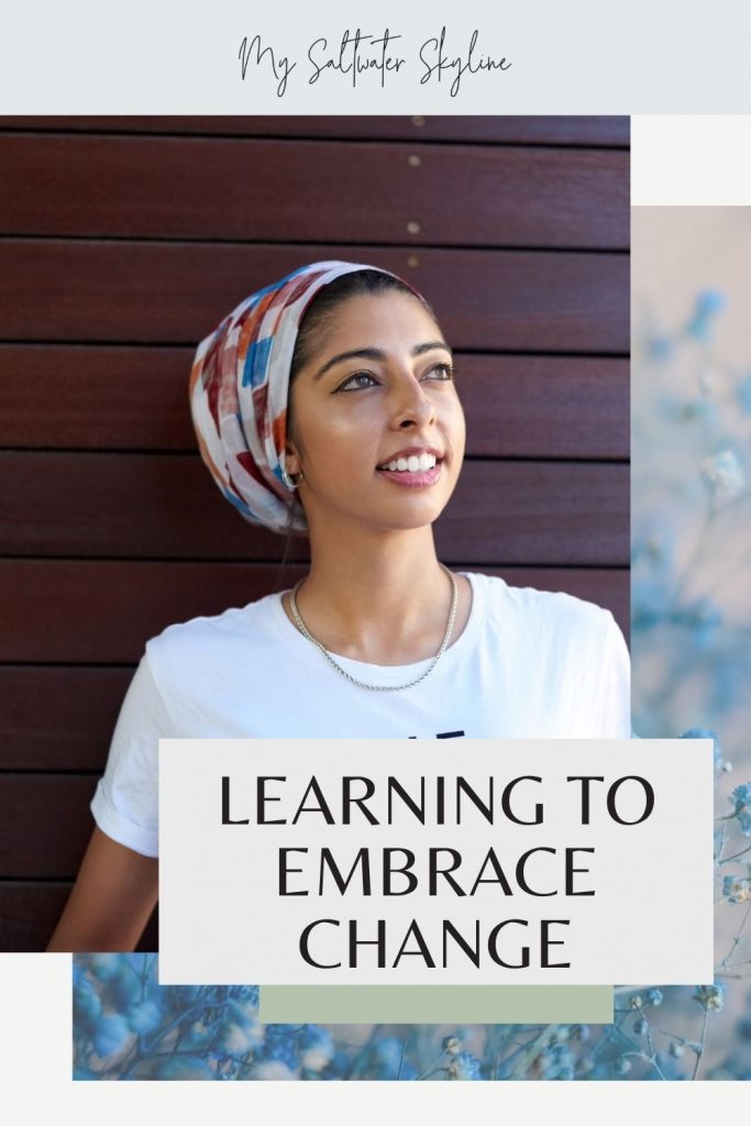 learning-to-embrace-change-blog-post-pin-woman-smiling-against-wooden-backgroung-hair-wrapped-in-cloth