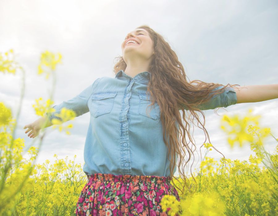arms-outstretched-in-field-of-flowers-feeling-good