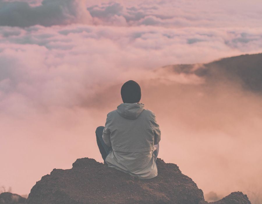 man-on-mountain-mist-sitting-in-stillness
