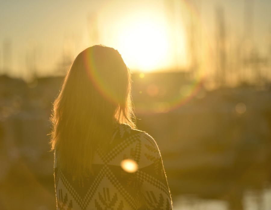 woman-facing-sunset-stillness-accepting-what-is