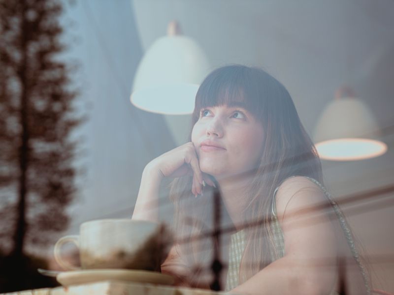 womam-at-cafe-window-deep-thought-example-of-limiting-beliefs-blog-post