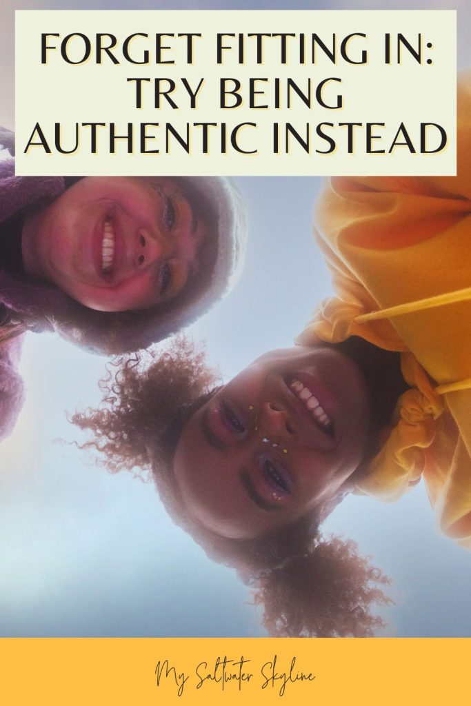 two-teenage-girls-looking-down-at-camera-smiling-fitting-in-autheticity-blog-pin