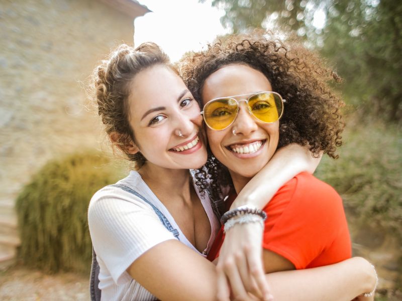 two-woman-hugging-smiling-at-camera-make-a-difference-blog