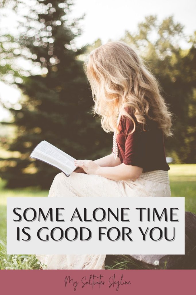 woman-sitting-in-field-long-blonde-hair-reading-book-alone-time-blog-post-pin