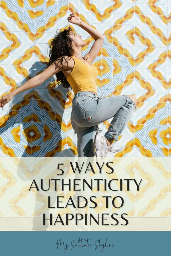 authenticity happiness pin woman dancing yellow shirt blue jeans yellow patterned wall 