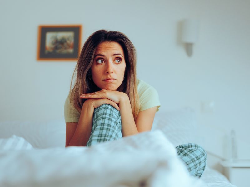 women on bed deep in thought being honest with yourself blog post